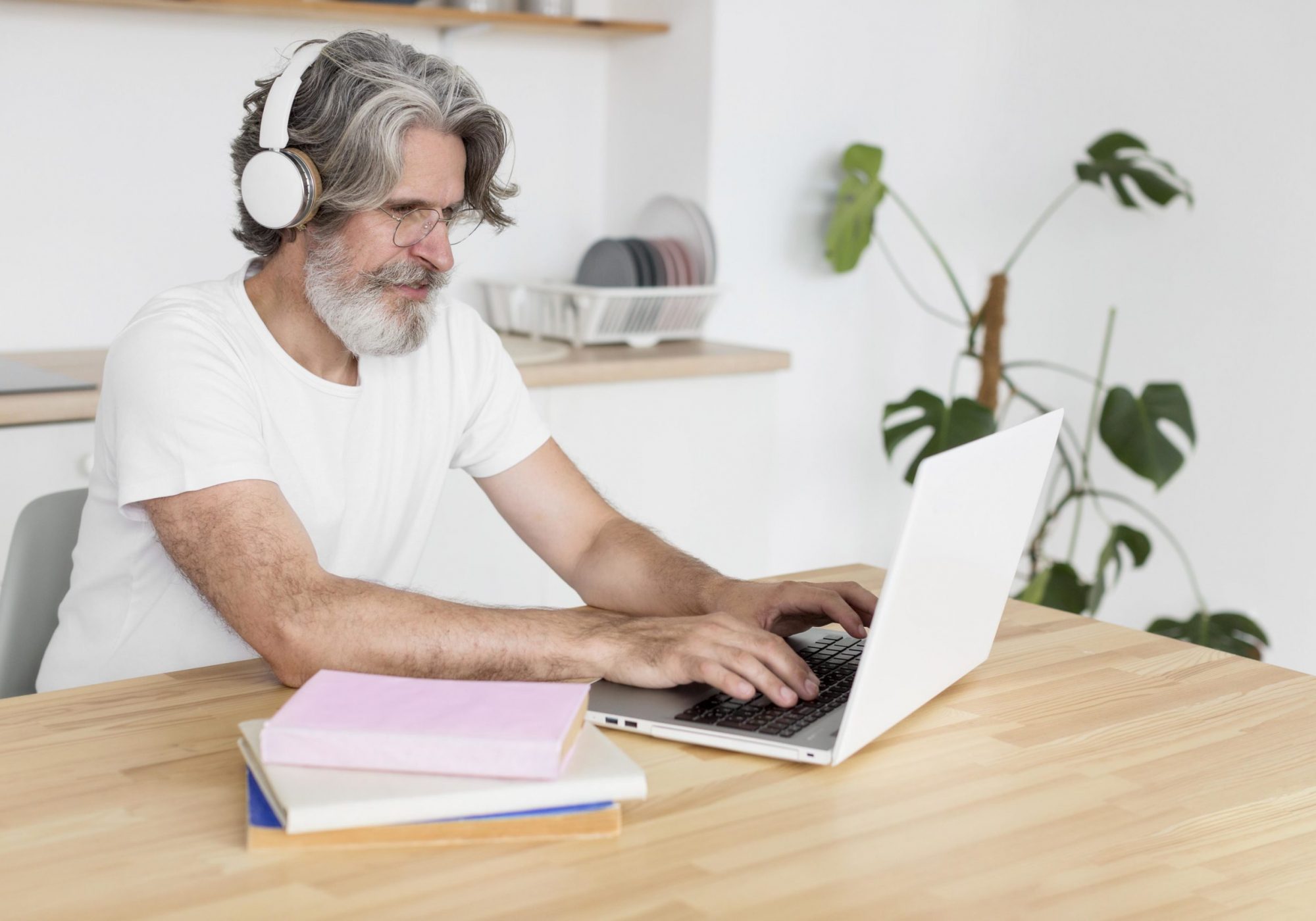 mid-shot-man-desk-using-laptop